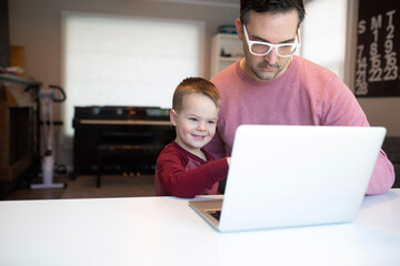 dad and son on a computer