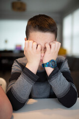 worried boy holding his face