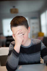 worried boy holding his face