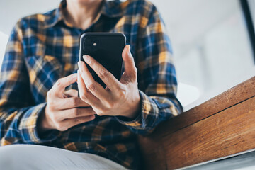 using cell phone hand holding mobile texting message contact us.chatting,search internet information in office.technology device communication connecting.