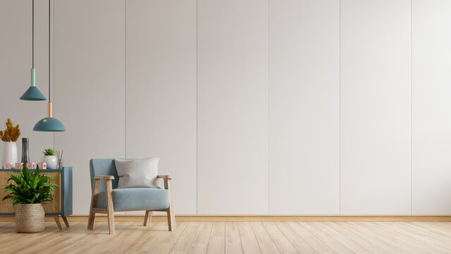 The interior has a blue armchair on empty white wall background.