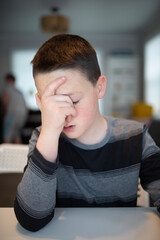 worried boy holding his face