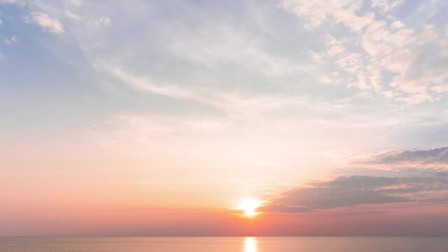 Soft blue and peach pink color sunset(sunrise) sky. Aerial view footage B roll nature landscape background in the sunny weather summertime.sundown into the sea and the light reflected on water surface
