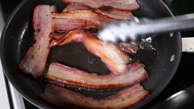 Italian pancetta frying in a pan