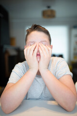 worried boy holding his face