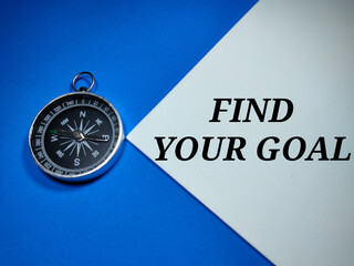 Selective focus.Word FIND YOUR GOAL with compass on a blue and white background.Business...