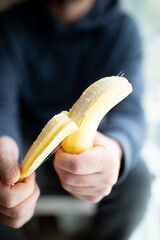 man peeling a banana