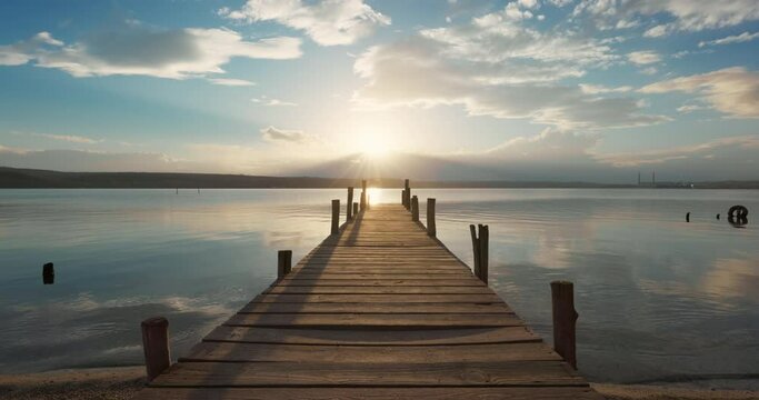 Small Dock and beautiful colorful sunset over lake, 4K video
