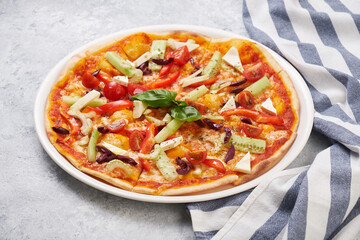 Fresh Vegetarian Vegetable Pizza. Tomato and Paprika Pepper, Cucumber and Olives Cheese Mozzarella on Baked Cake Plate. Delicious Traditional Italian Classical Dish Food
