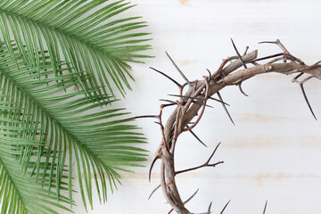 crown of thorns and green palm leaves