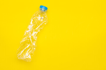 Plastic bottle on yellow background with copy space