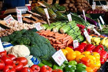 Vegetables for sale in the high stalls at the Pike Place Market. This farmer market is a famous sight in downtown of Seattle.
