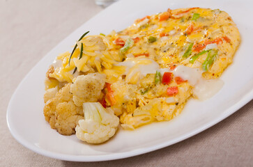 Fototapeta na wymiar Baked omelet with cauliflower on a plate. High quality photo