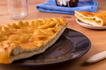 Pie on a plate on the table. Breakfast or lunch. Food photo.