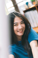 Portrait of happy young adult asian woman face smiling with teeth.