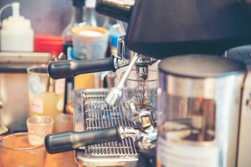 Coffee barista make espresso shot from coffee maker hot cup. Cappuccino with milk in italian coffee shop cafe. Close up hands of barista use machine make brown latte art for customer cafeteria.
