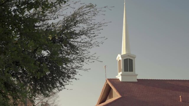 LDS Church Building Roof White Spire during Sunrise Zooming Out 4K
