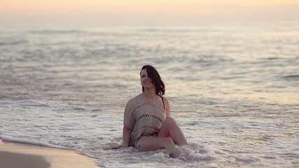 woman walking on the beach at sunset