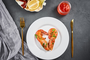 Two shrimps in shape of heart on the plate, top view. Love concept