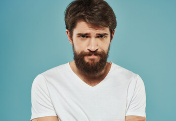 Portrait of a handsome man on a blue background with a cropped beard look