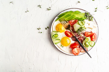 Keto breakfast with eggs, avocado, tomatoes, bacon and cheese. Ketogenic paleo diet. banner, catering menu recipe place for text, top view