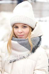 beautiful caucasian teen girl in light warm clothes outdoors in winter