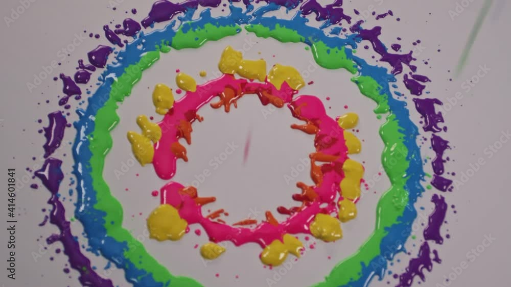 Poster the color drops in circles on a spinning white background. when the color drops, it will radiate int