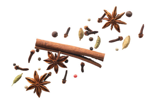 various flying spices for making masala tea isolated on white background
