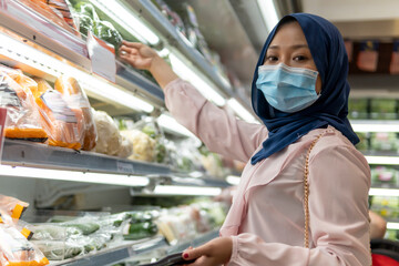 Cute Malay Girl at the mall going shopping wearing face mask