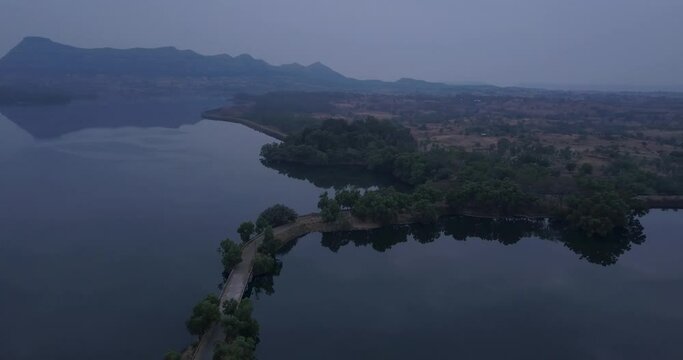 Beautiful Nature Landscape With Reflections Through Pristine Lake At Trimbakeshwar, Western Ghats Of Maharashtra, India. - Aerial Drone Shot 