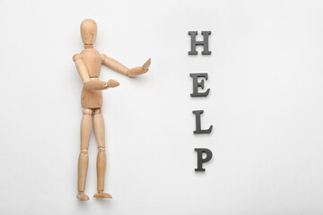 Wooden mannequin with word HELP on white background