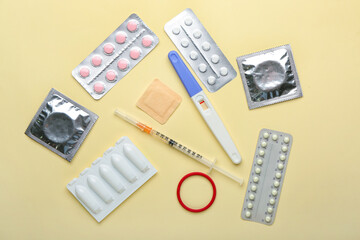 Different contraceptives and pregnancy test on color background