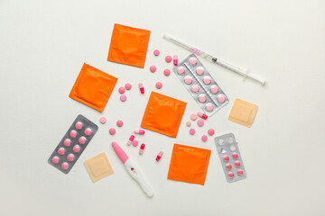 Different contraceptives and pregnancy test on white background