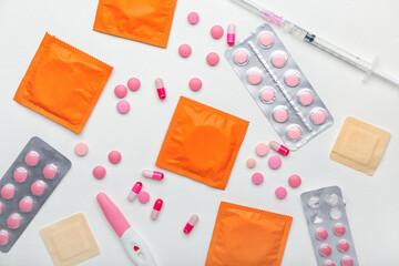 Different contraceptives on light background