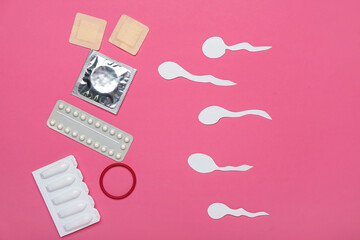 Different contraceptives and spermatozoa made of paper on color background. Safe sex concept