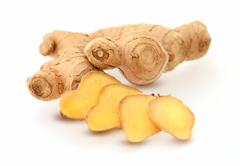 Ginger root fresh, raw cutted into slices isolated on white
