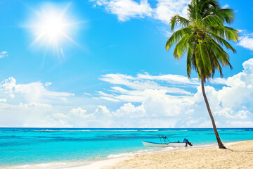 Tropical yellow sand beach landscape, turquoise sea water, blue sky,  bright sun, white clouds, green palm tree, boat, summer holidays, caribbean vacation, travel on Saona island, Dominican Republic