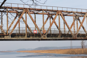 Old railway bridge and river in winter.Travel photo