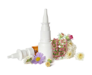 Bottles with drops and flowers on white background