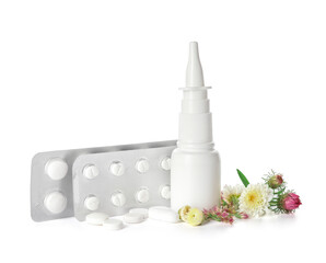 Bottle with drops, flowers and pills on white background