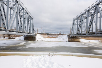 City Riga, Latvia. Old railway bridge and river in winter.Travel photo
