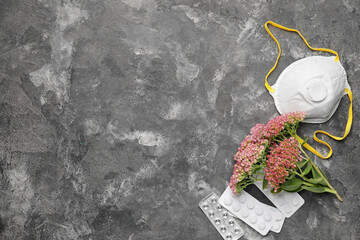 Pills, flowers and respirator on dark background