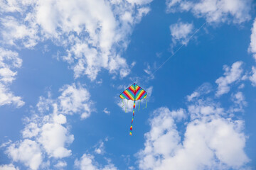 Fototapeta na wymiar Colorful kite flying in blue sky