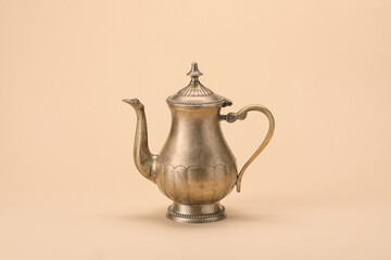 Stylish teapot on color background