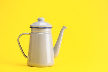 Stylish teapot on color background