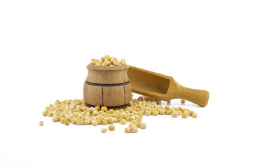 Dried peas spilling from a wooden barrel