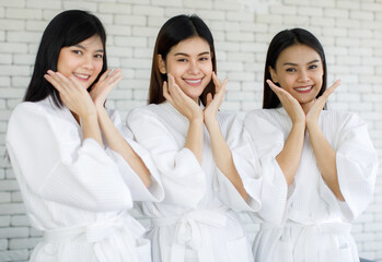 Portrait 3 asian adults women with long black hair wearing apa style white robes Smiling and looking at the camera her hands touched on her face looked happy with her skin face.  - obrazy, fototapety, plakaty