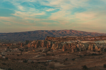 landscape of the rose and sword valleys in cappadocia, turkey, with a mountain in the background