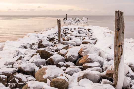 Tuja coast of Vidzeme sea shore Rīgas jūras līcis Gulf of Riga winter violet sunset rock formation path frozen water cloudy - Powered by Adobe