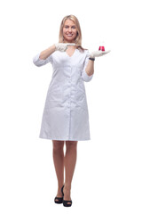 female laboratory assistant pointing at the liquid in the laboratory bottle .